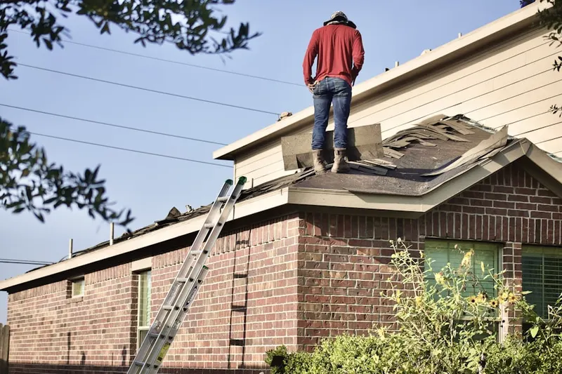 Professional roofer working on a residential roof in Coquina Key